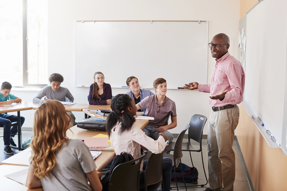 Lecturer leading an icebreaker game for students